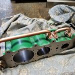 two shiny neatly bent steam pipes are insalled on the triple explansion modle steam engine
