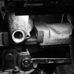 Black and white workshop photo bearing scraping