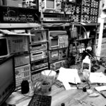 Black and white workshop photo Electronic test equipment
